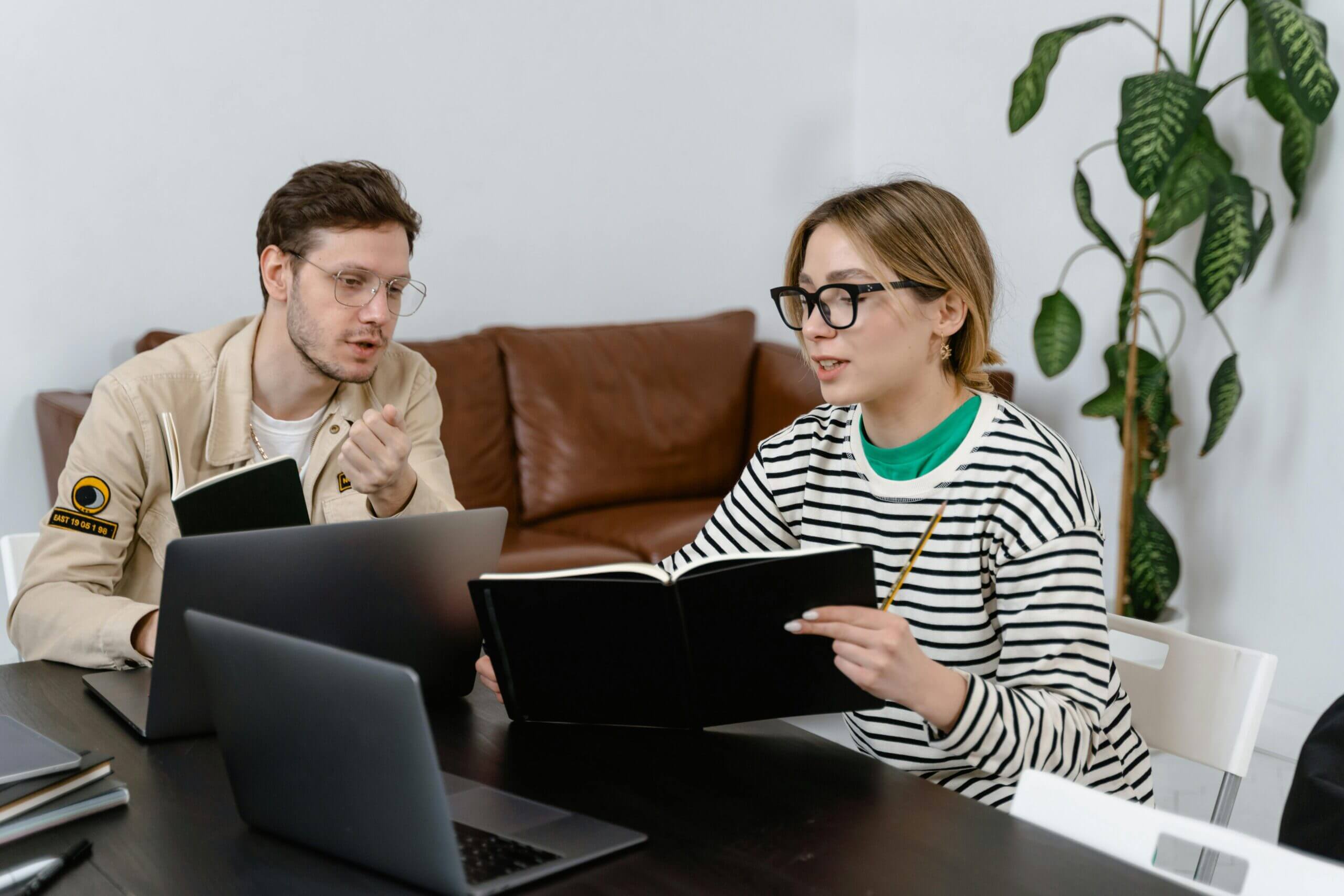 An entrepreneur presenting a new business idea to a colleaque, symbolizing "entrepreneur stress management.