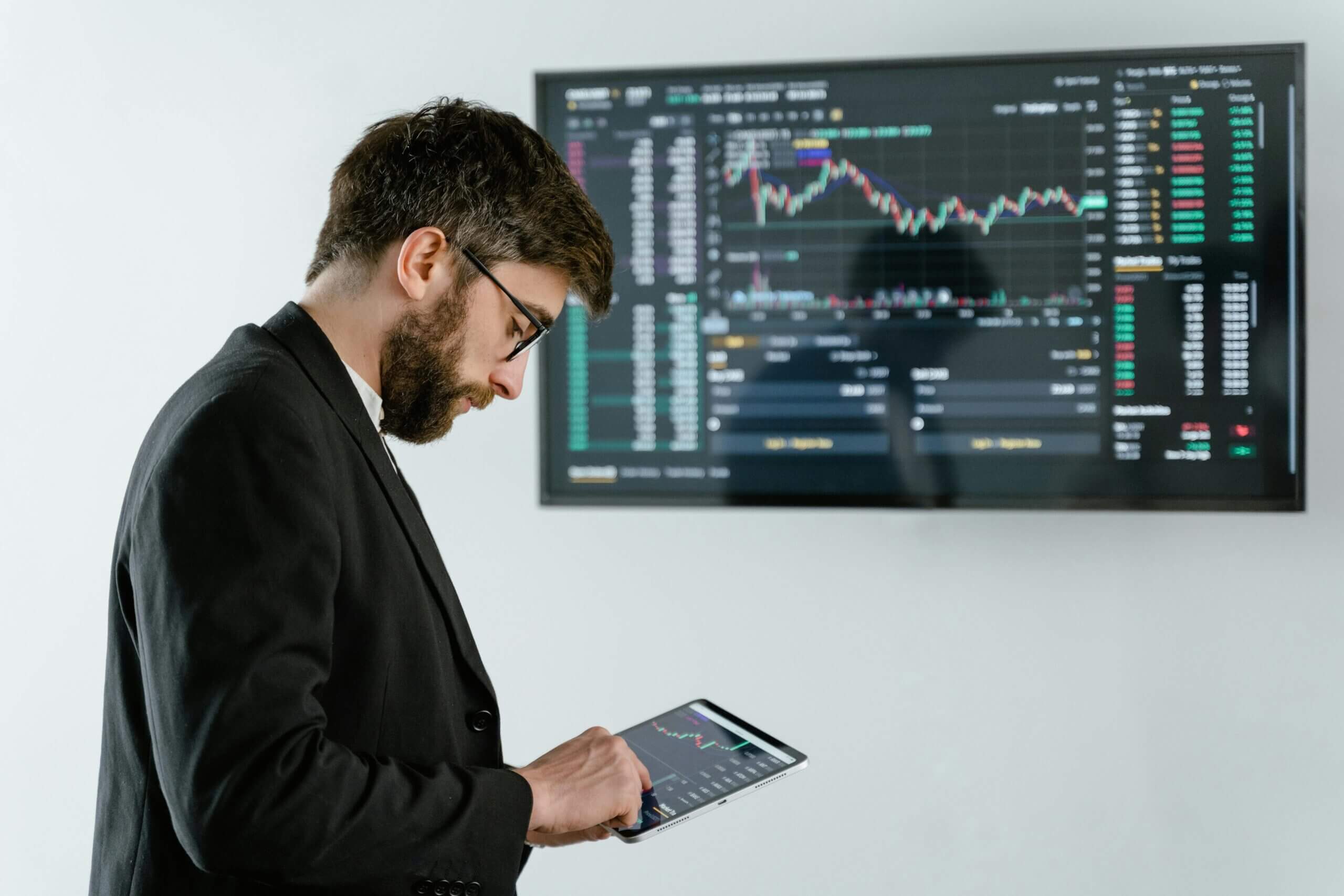 Small business owner exploring digital transformation tools on a digital tablet with graphs and analytics in the background