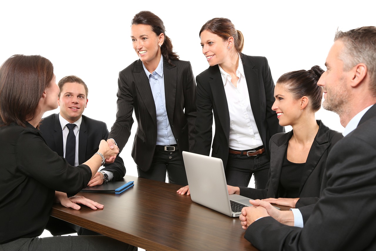 A diverse group of business leaders collaborating and discussing strategies in a meeting room, illustrating how to lead with purpose for driving business success