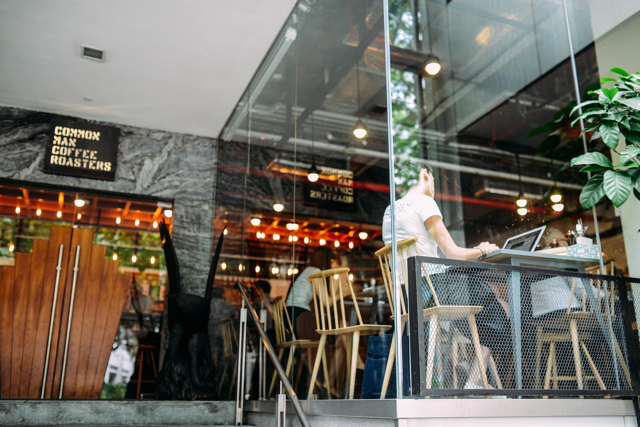 A freelancer working on a laptop at a cafe, representing the flexibility of the gig economy