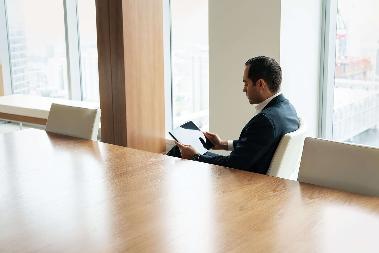 Digital transformation in action: employee using a tablet to analyze business data in a modern office setting