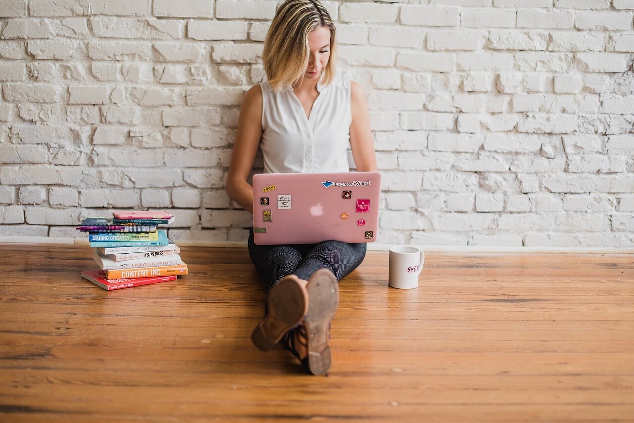 Startup owner analyzing financial reports on a laptop with charts and graphs on the screen