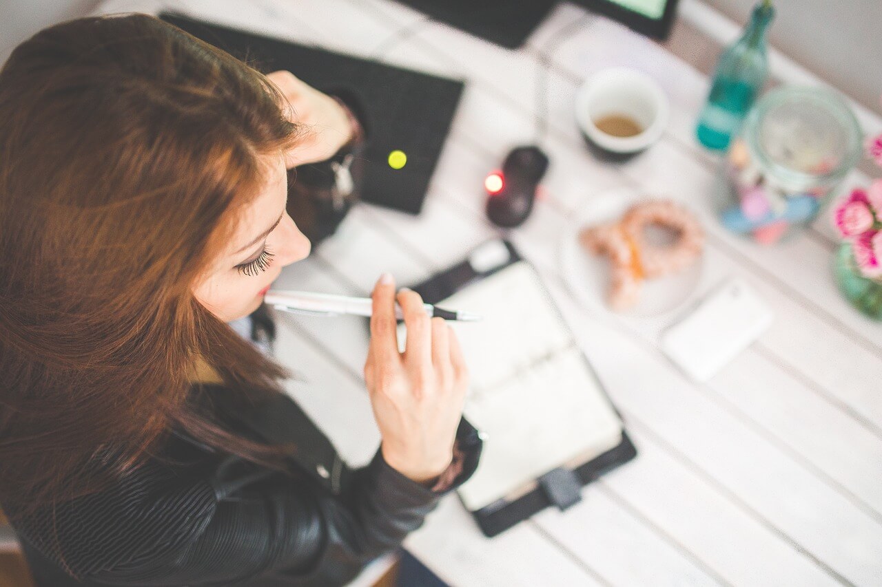 Entrepreneur working efficiently at a desk with productivity tools like a laptop, planner, and smartphone, showcasing smart time management techniques