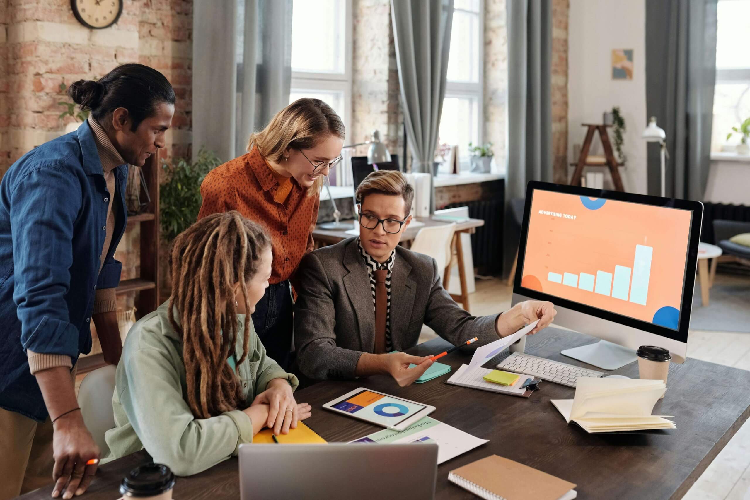 A business team collaborating on a sustainability-focused strategic plan with charts, eco-friendly icons, and a green business strategy framework